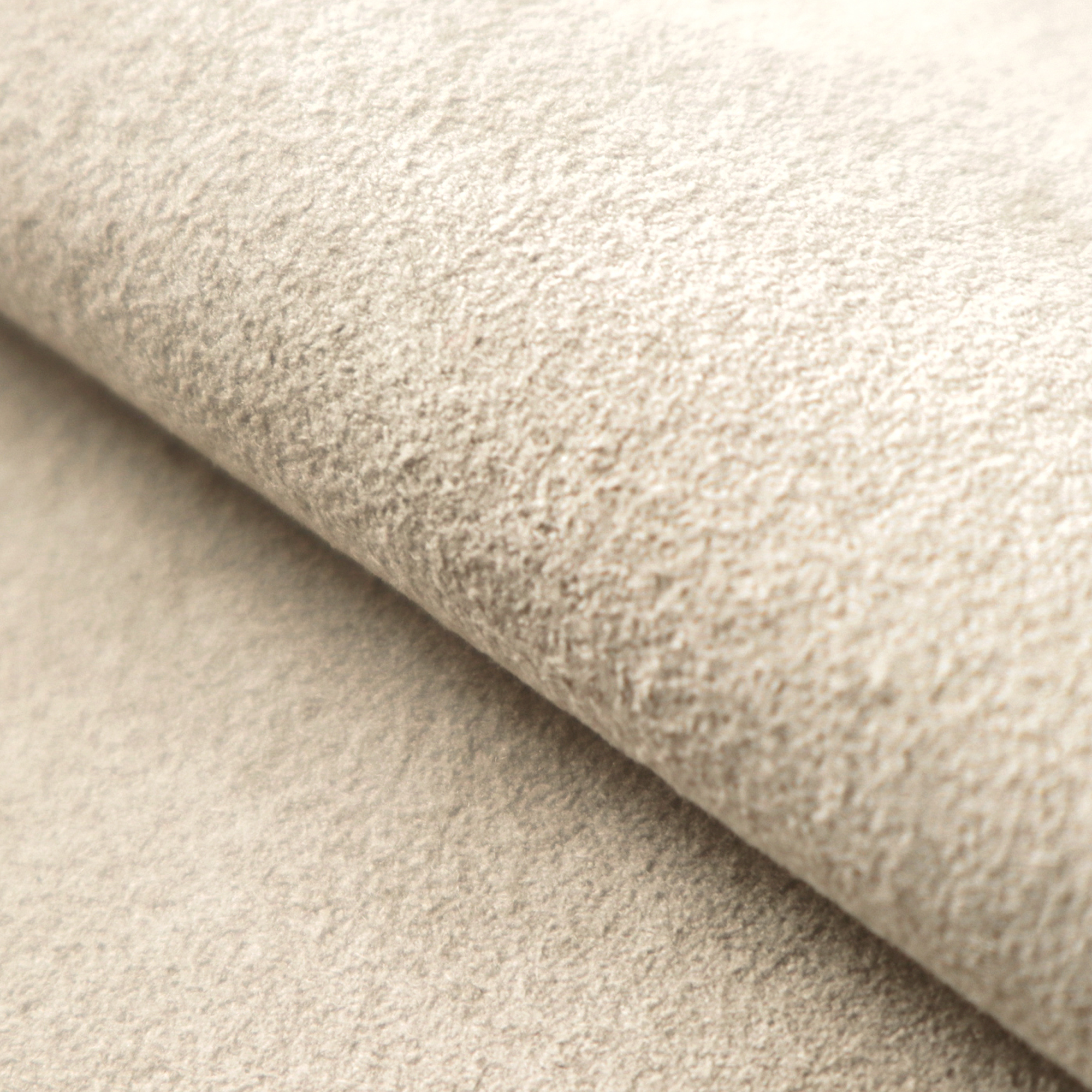 A close-up of the Doeskin colour Ultrasuede fabric with a soft, textured surface and a folded edge.