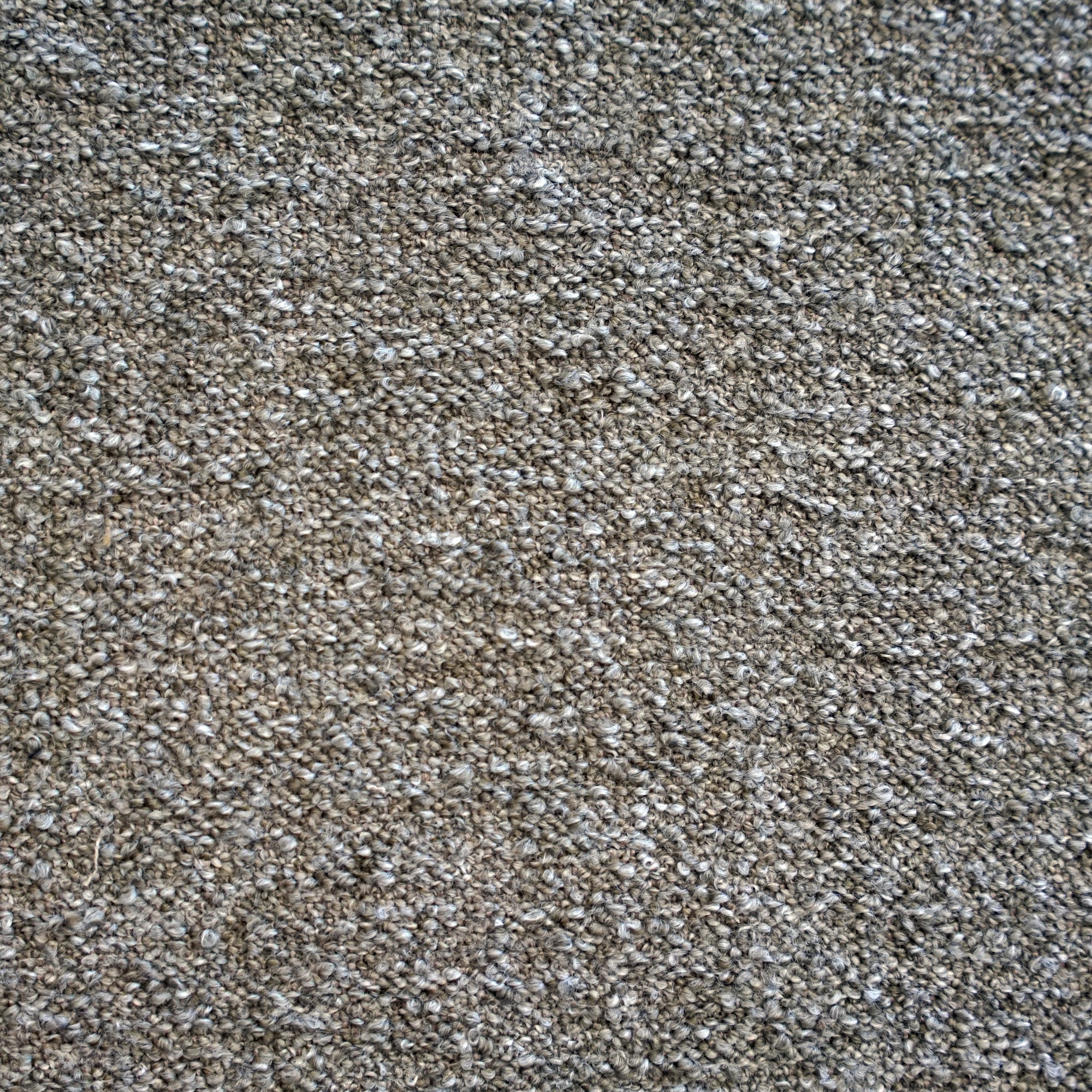 A close-up texture shot of a dense, tightly knotted Boucle fabric in a taupe-brown and gray colorway | Case Furniture