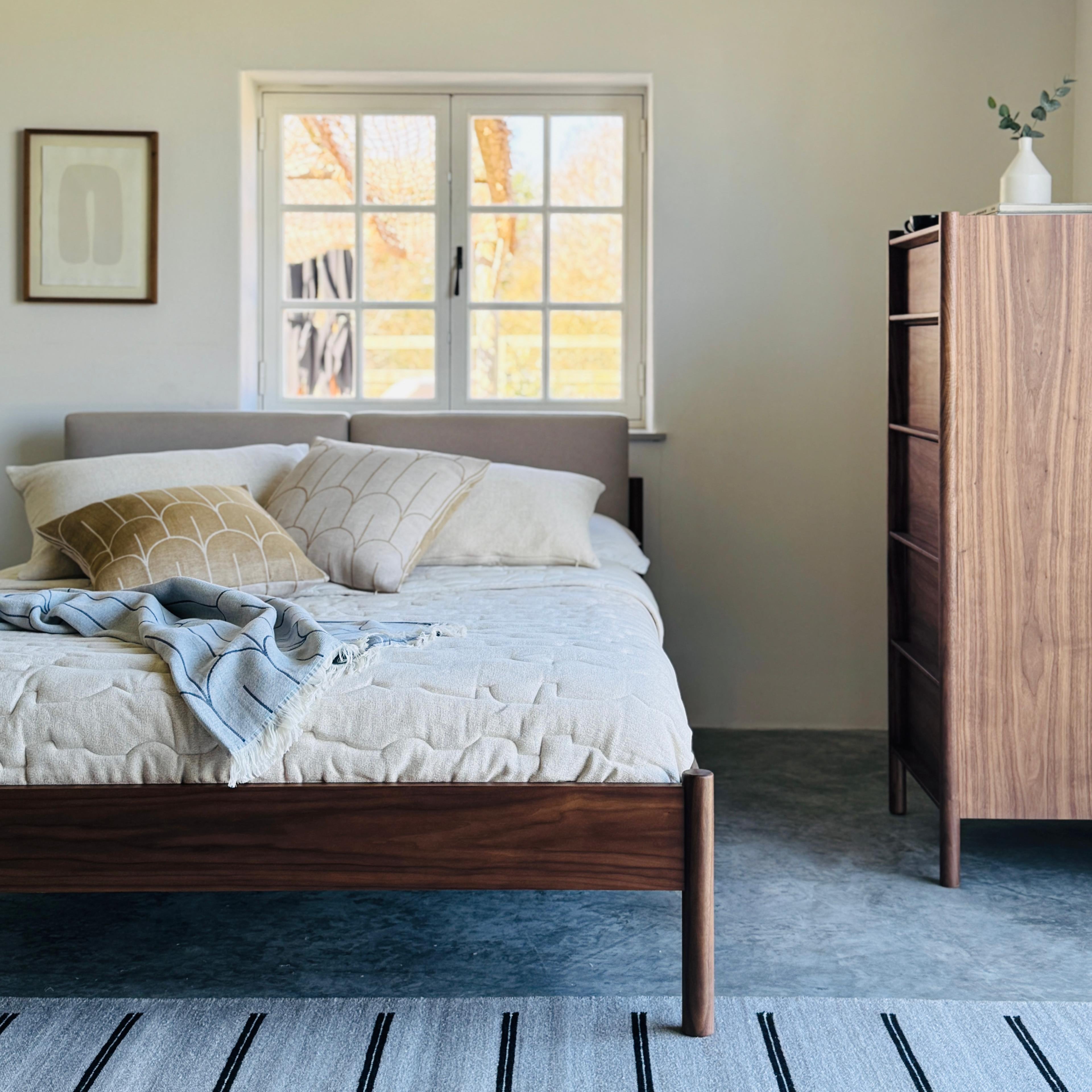 Pala bed and tallboy shot from the end of the bed in a modern bedroom with polished concrete floor 
