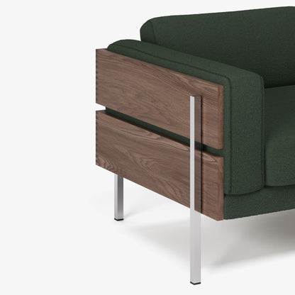 Green sofa with wooden side on a white background
