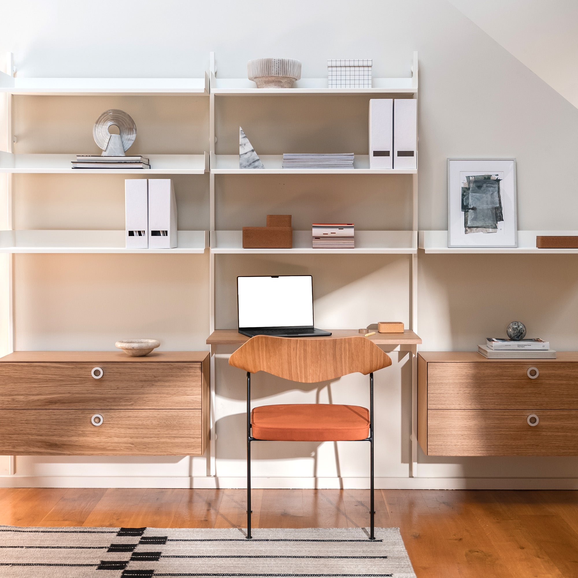 Slot shelving in white with two drawer cabinets and a desk in oak with a 675 chair with oak back and black frame with clove ultrasuede seatpad. 