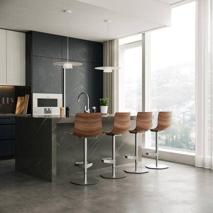 Modern kitchen with dark marble island and wooden bar stools lightened by the sculptural sum pendant