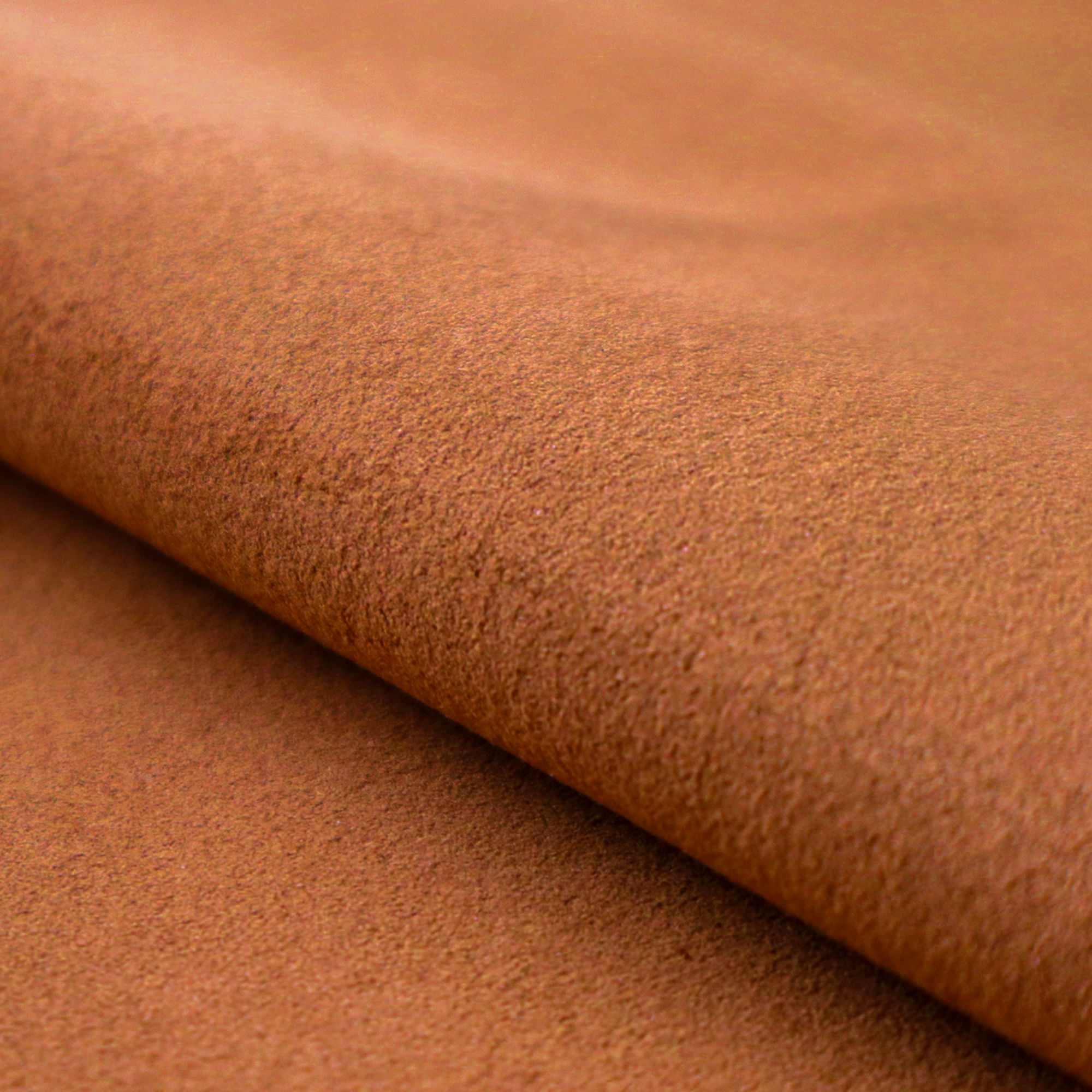 A close-up of the Clove colour Ultrasuede fabric with a soft, textured surface and a folded edge.